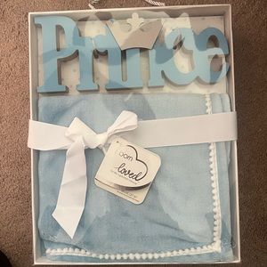 Plush blue baby blanket with “prince” room art